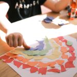 person holding pink and white heart print paper